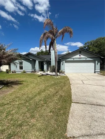 a view of a house with backyard and sitting area