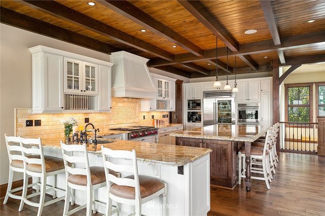 a kitchen with stainless steel appliances granite countertop a stove and cabinets
