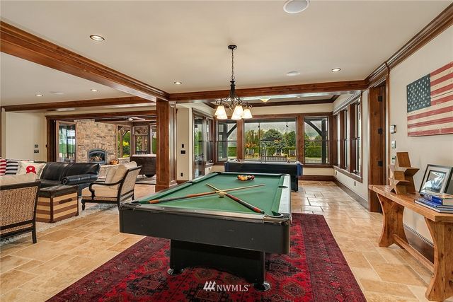 a living room with furniture a flat screen tv and a large window