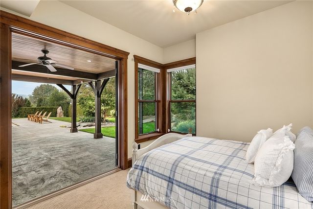 a bedroom with a bed and large window