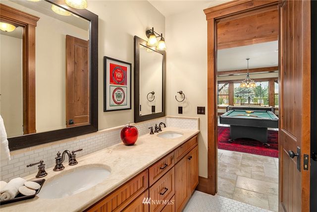 a bathroom with a tub sink and mirror