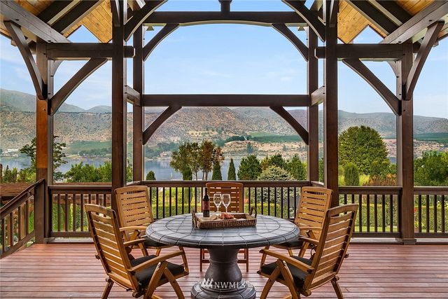 a view of a two chairs and table in the balcony