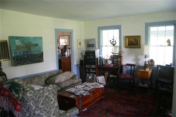 114 Hoyt Road Harwich, MA 02646 - Photo 3 of 12 a living room with furniture and a flat screen tv