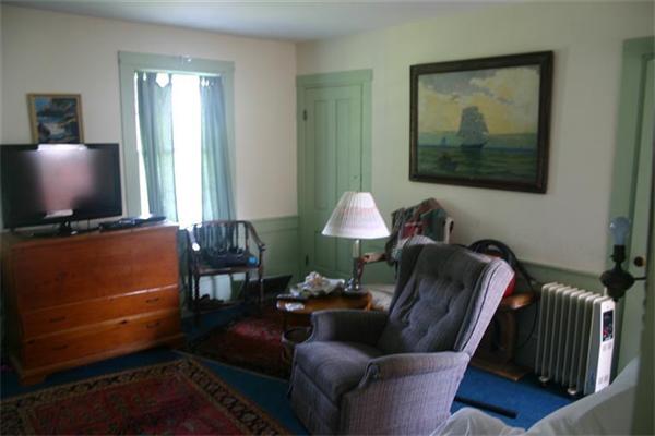 114 Hoyt Road Harwich, MA 02646 - Photo 4 of 12 a living room with furniture and a flat screen tv
