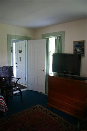 114 Hoyt Road Harwich, MA 02646 - Photo 8 of 12 a living room with furniture and a flat screen tv