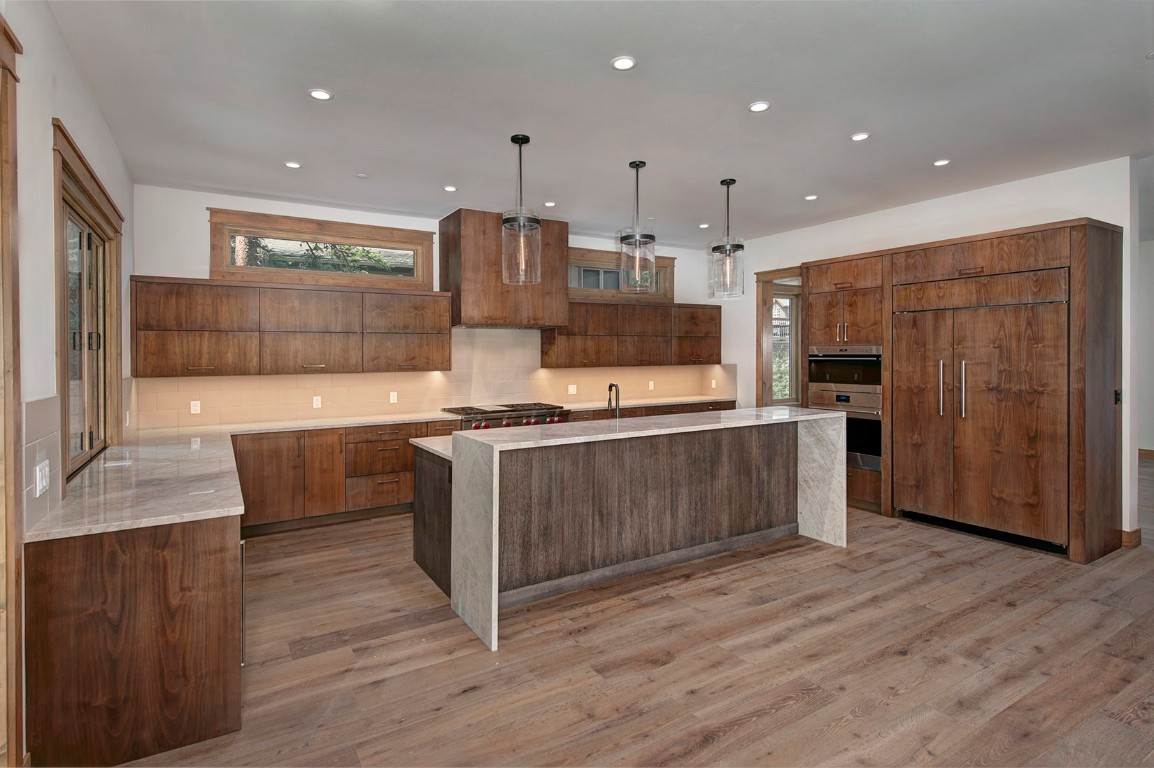 25 Tip Top Trail Keystone, CO 80435 - Photo 5 of 39 a kitchen with stainless steel appliances kitchen island granite countertop a stove a refrigerator and a wooden floors