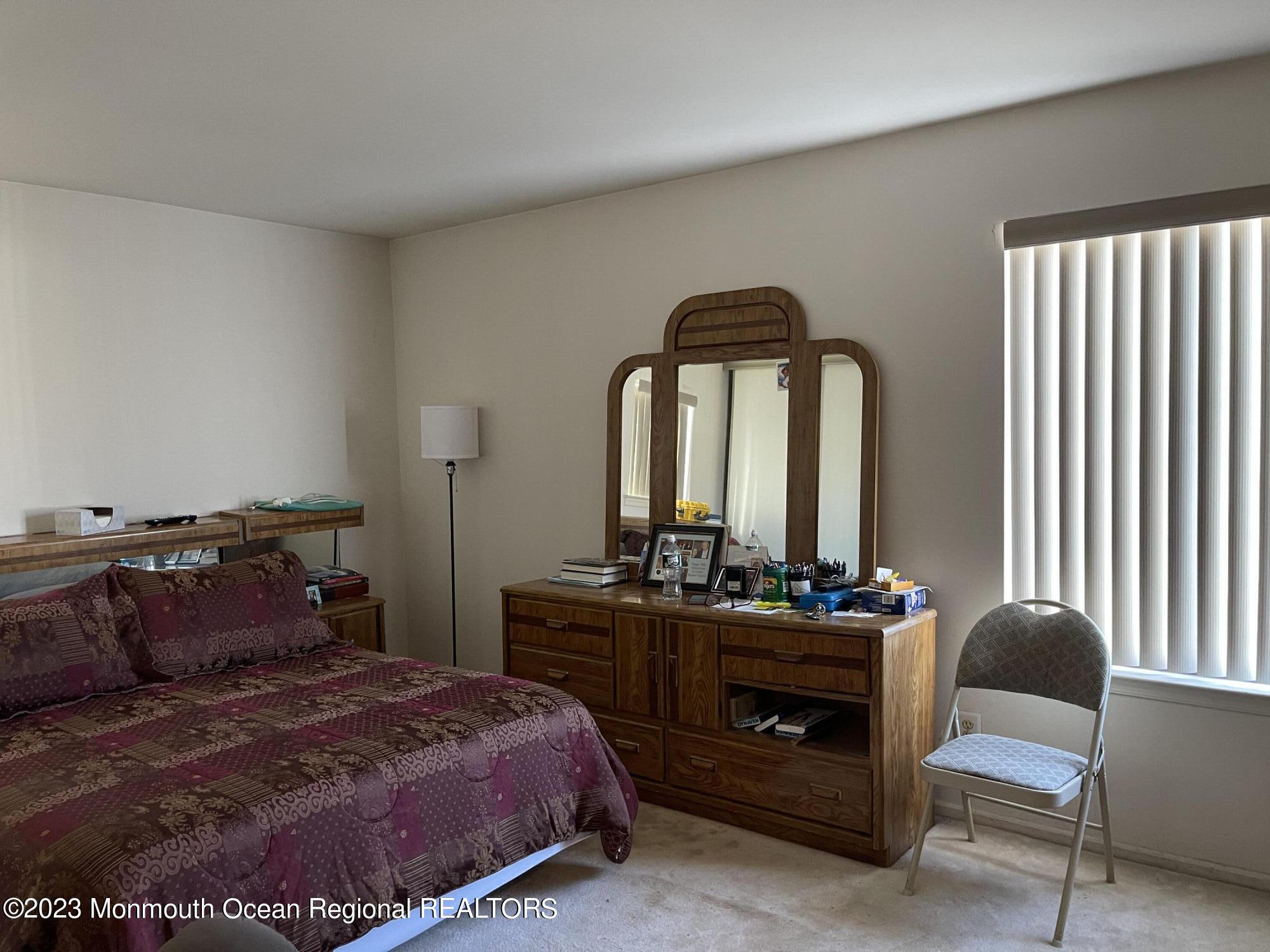 51 Cherry Bend Drive Howell, NJ 07731 - Photo 12 of 18 a bedroom with a bed and a table