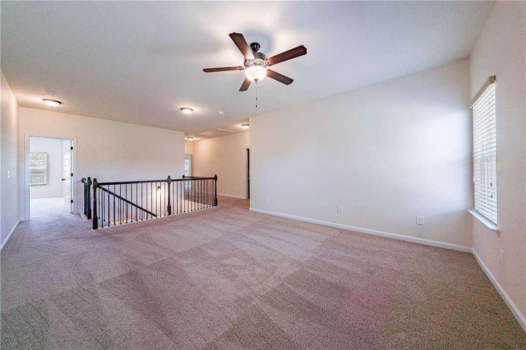 10 Edgewater Court Covington, GA 30016 - Photo 16 of 25 a view of a livingroom with a ceiling fan and window
