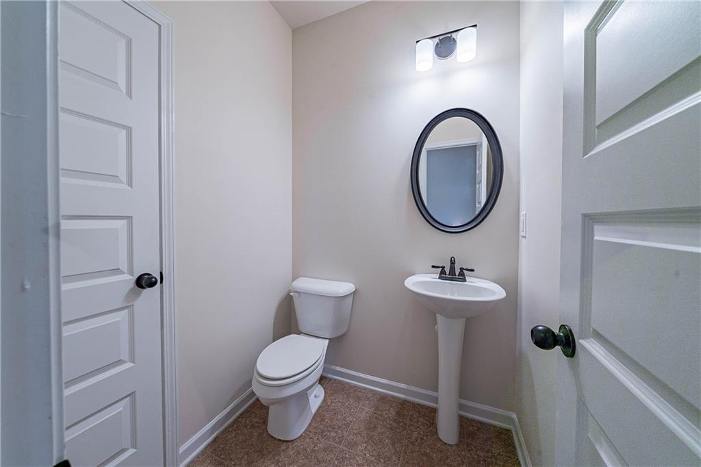 10 Edgewater Court Covington, GA 30016 - Photo 20 of 25 a bathroom with a toilet a sink and a mirror