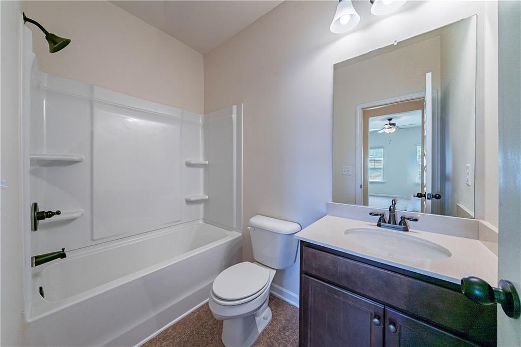 10 Edgewater Court Covington, GA 30016 - Photo 22 of 25 a bathroom with a sink toilet and shower