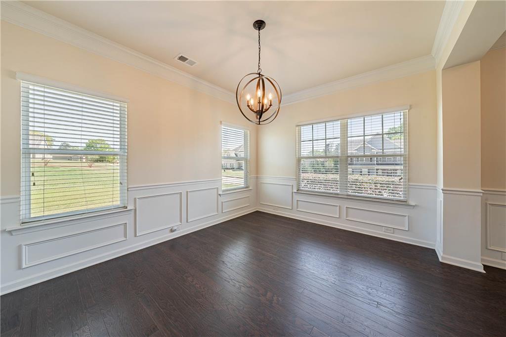 10 Edgewater Court Covington, GA 30016 - Photo 9 of 25 an empty room with wooden floor exposed radiator and windows