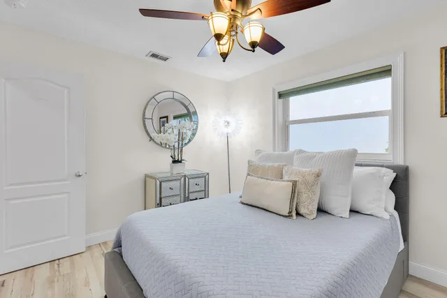 a bedroom with a bed and a chandelier