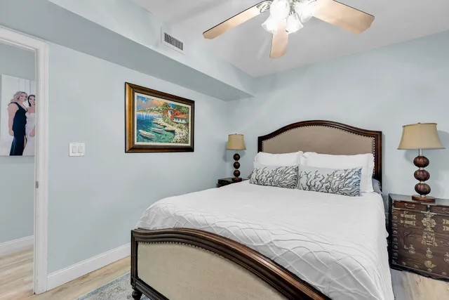 a bedroom with a bed and a painting on the wall