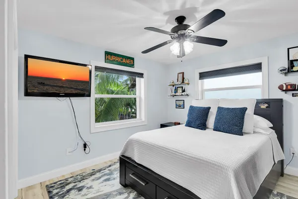 a bedroom with a bed and a lamp on dresser