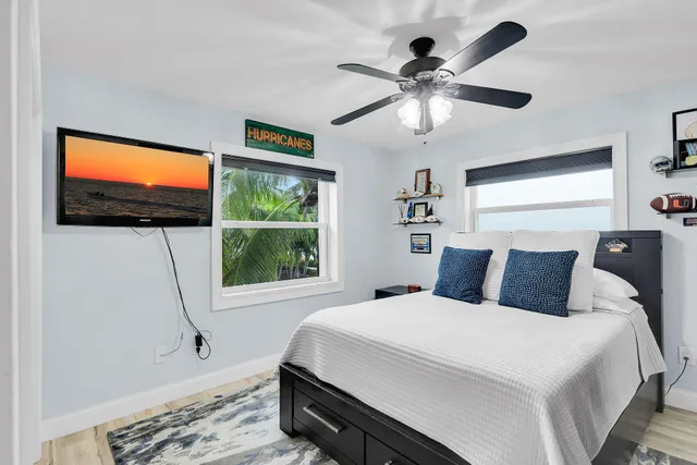 a bedroom with a bed and a lamp on dresser