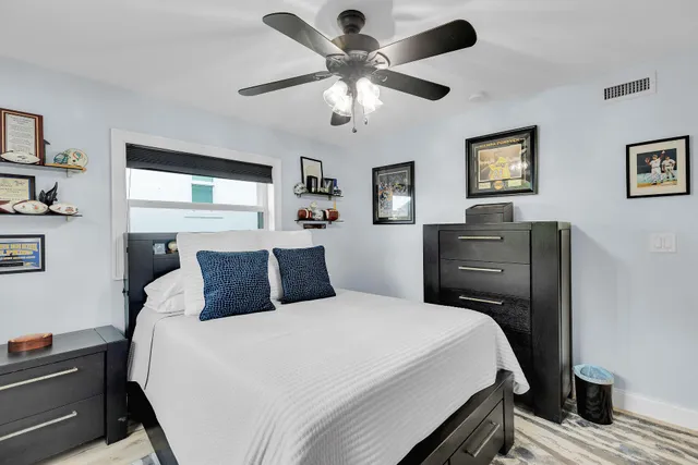 a bedroom with a bed and a view of balcony