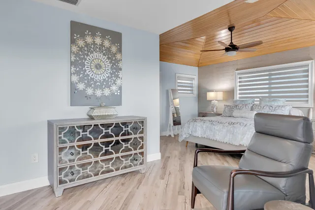 a large bed sitting in a bedroom next to a window