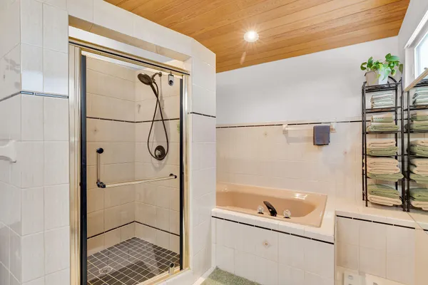 a bathroom with a double vanity sink a mirror and shower