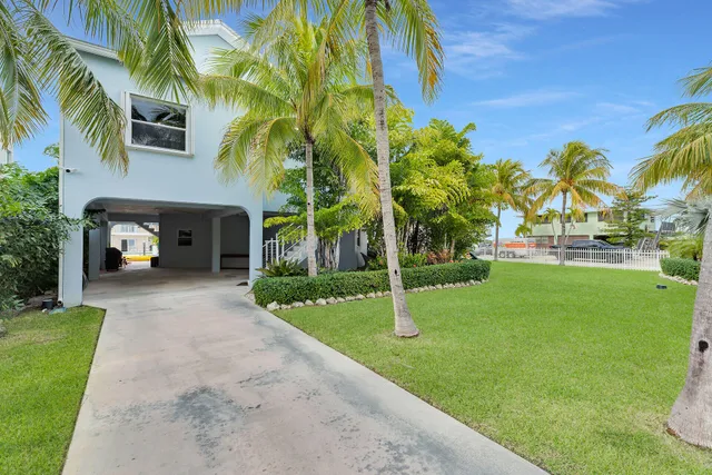 an empty room with large windows and outdoor view