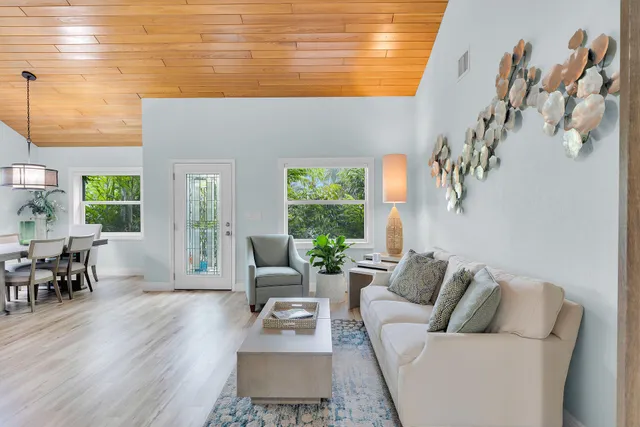 a living room with furniture and stairs