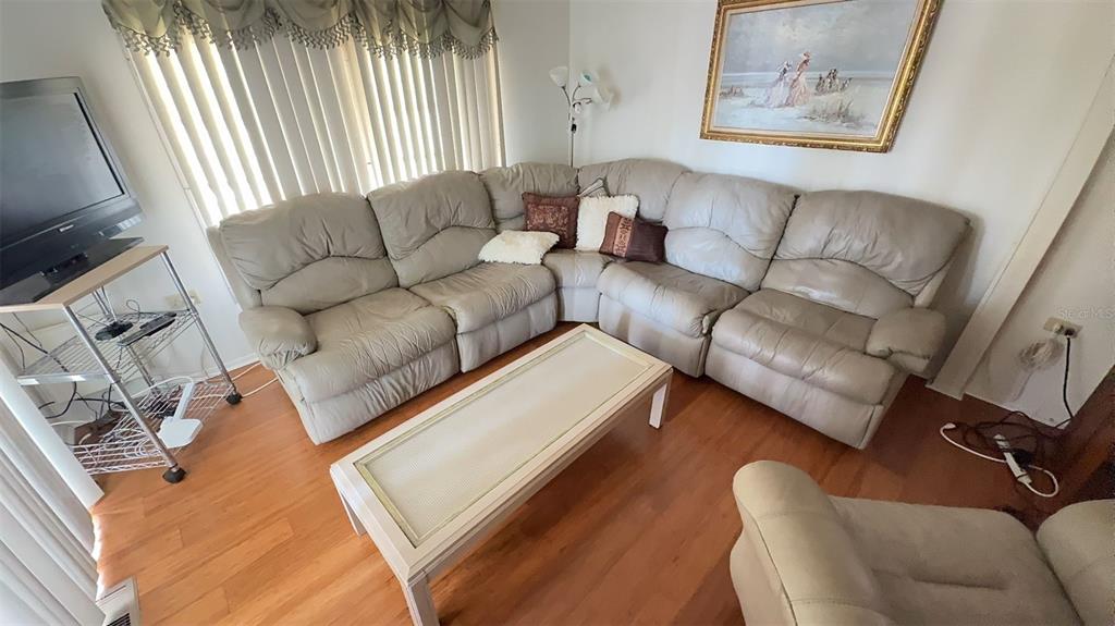 4851 West Gandy Boulevard, Unit B5L5 Tampa, FL 33611 - Photo 12 of 46 a living room with furniture and a couch