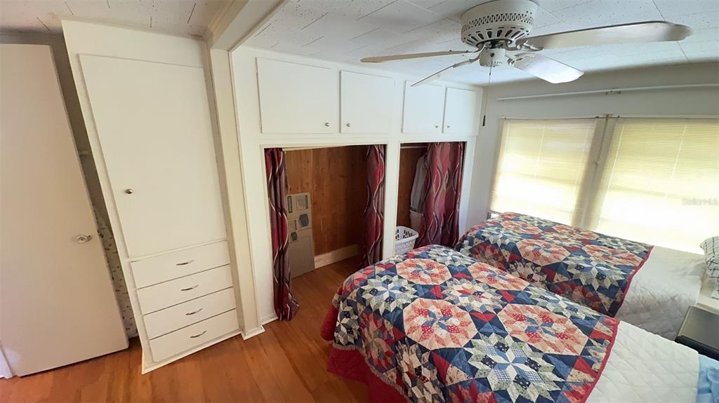 4851 West Gandy Boulevard, Unit B5L5 Tampa, FL 33611 - Photo 19 of 46 a bedroom with a bed and a dresser