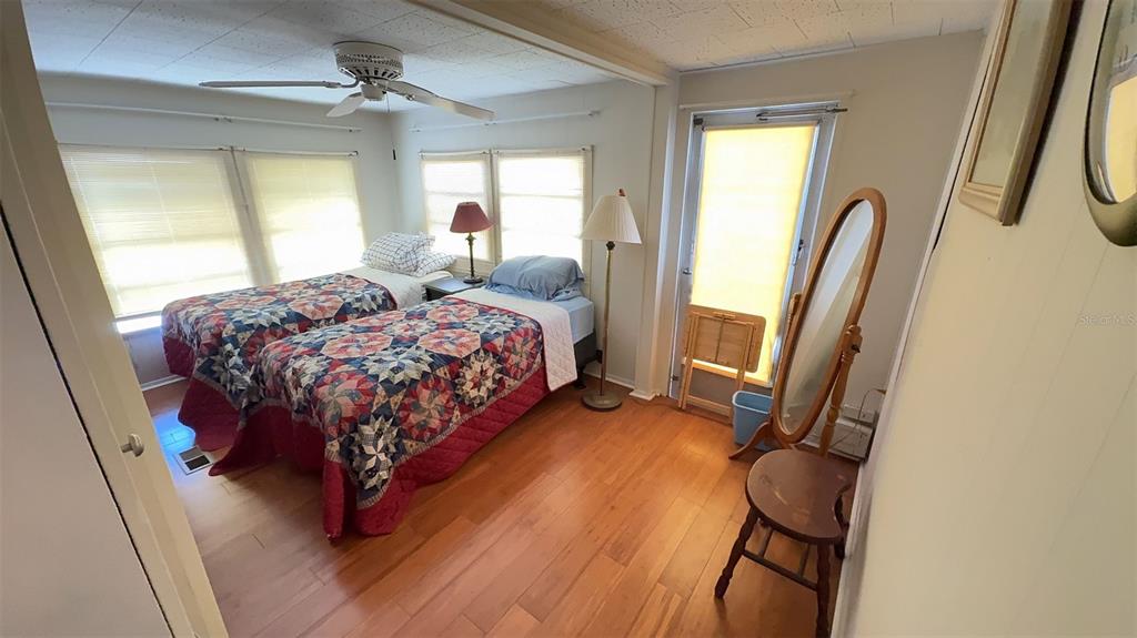 4851 West Gandy Boulevard, Unit B5L5 Tampa, FL 33611 - Photo 20 of 46 a bedroom with a bed and a mirror