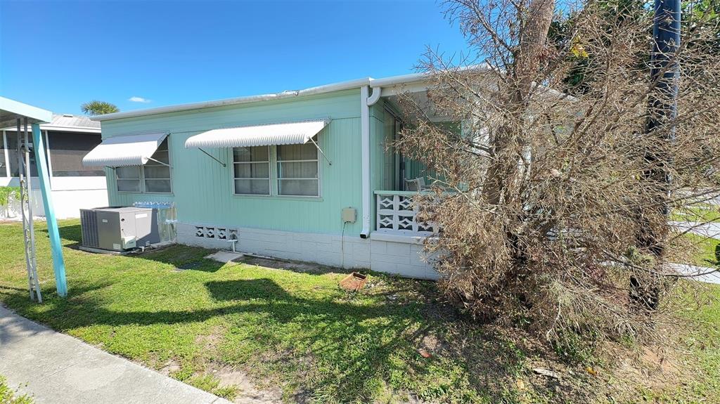 4851 West Gandy Boulevard, Unit B5L5 Tampa, FL 33611 - Photo 26 of 46 a view of a house with backyard and sitting area