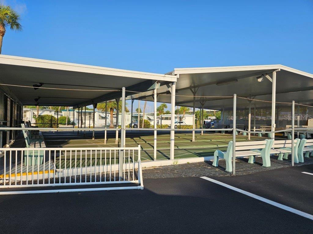 4851 West Gandy Boulevard, Unit B5L5 Tampa, FL 33611 - Photo 34 of 46 a view of a balcony with floor to ceiling window and wooden floor
