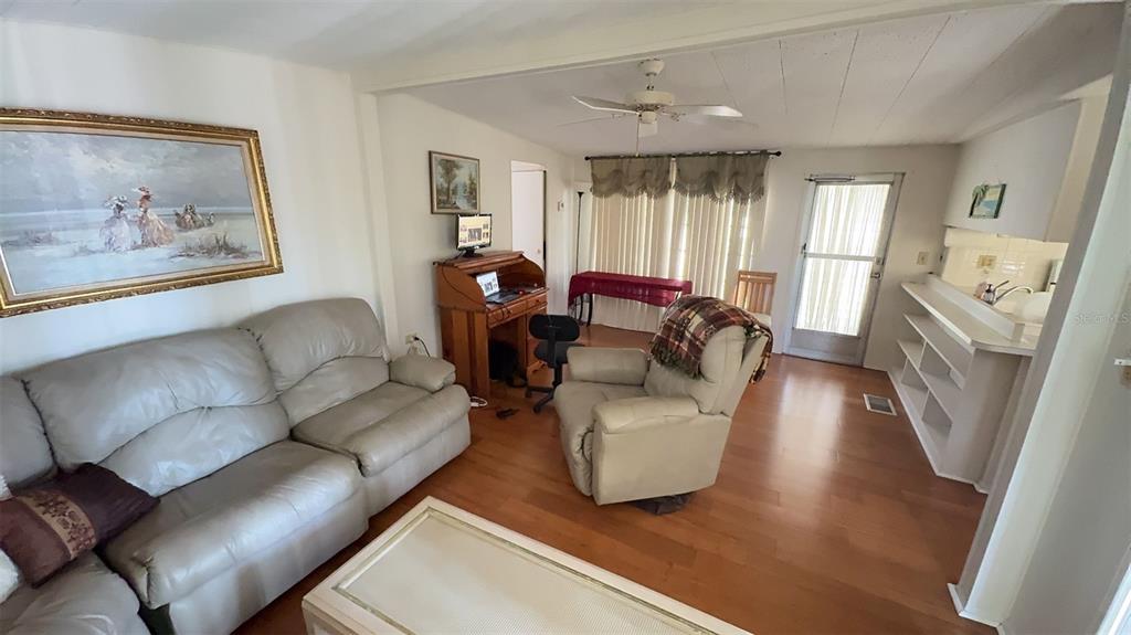 4851 West Gandy Boulevard, Unit B5L5 Tampa, FL 33611 - Photo 10 of 46 a living room with furniture and a large window