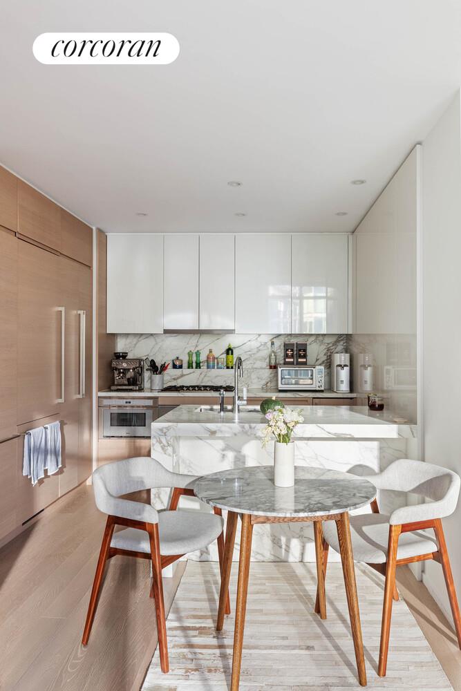 30 Riverside Boulevard, Unit 22F Manhattan, NY 10069 - Photo 2 of 16 a kitchen with stainless steel appliances kitchen island granite countertop a refrigerator a stove a sink and white cabinets with wooden floor