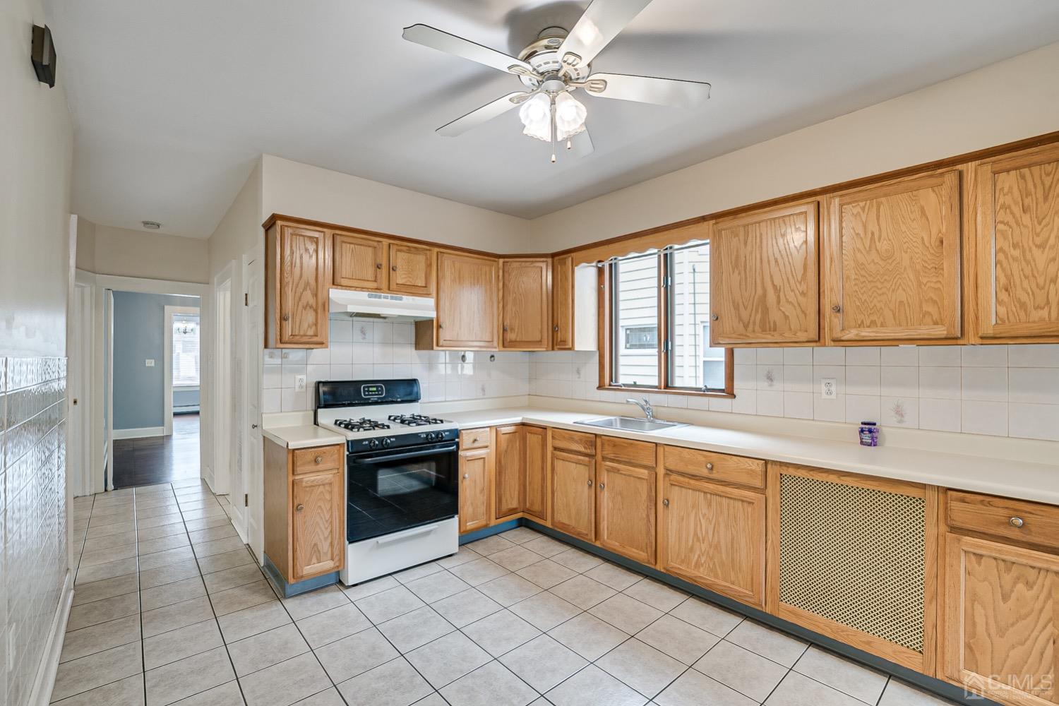 906-908 Kilsyth Road Elizabeth, NJ 07208 - Photo 8 of 50 a kitchen with a stove sink and cabinets