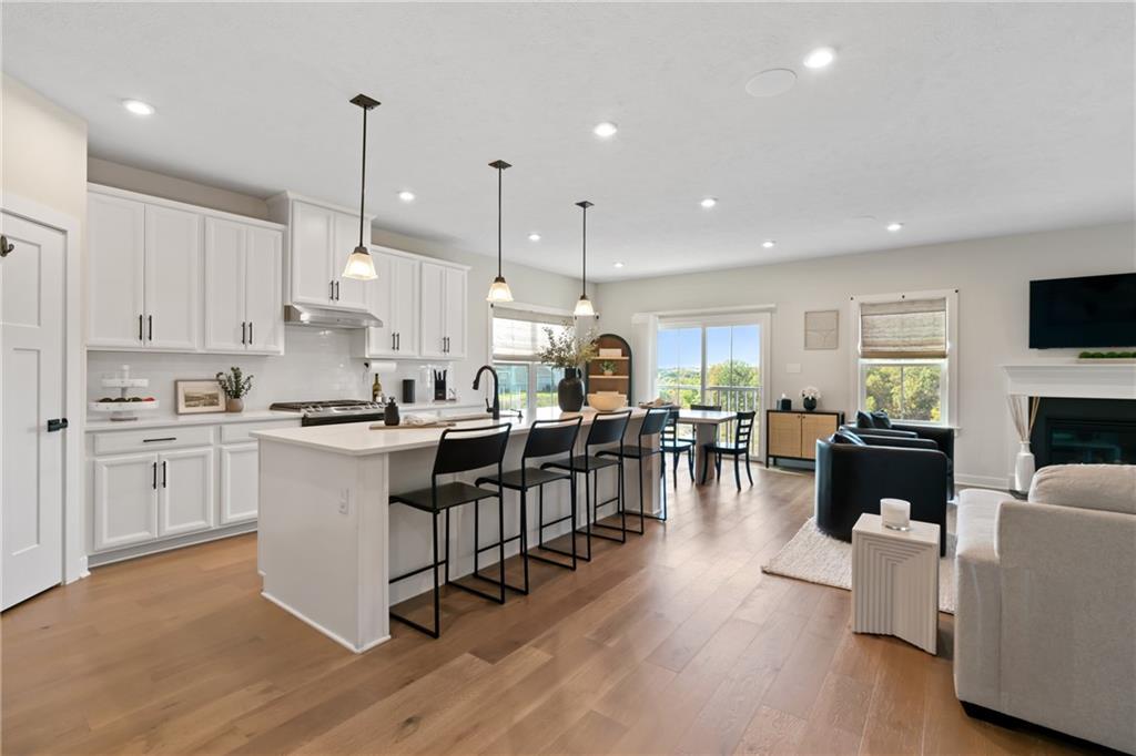 114 Marketplace Avenue Coraopolis, PA 15108 - Photo 2 of 32 a open kitchen view with stainless steel appliances granite countertop a stove a sink a oven and a dining table with wooden floor
