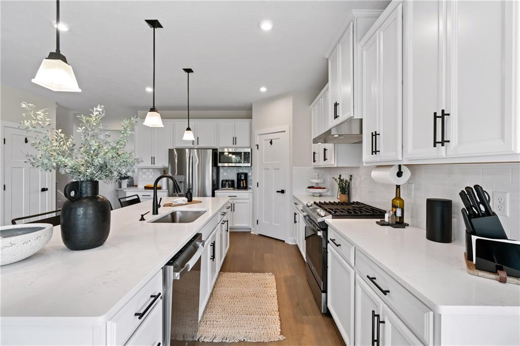 114 Marketplace Avenue Coraopolis, PA 15108 - Photo 4 of 32 a kitchen with kitchen island a white counter space a sink a stove and refrigerator
