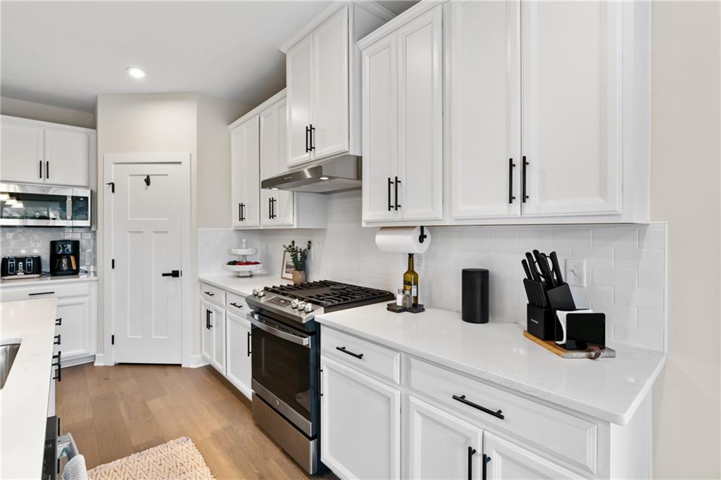 114 Marketplace Avenue Coraopolis, PA 15108 - Photo 5 of 32 a kitchen with stainless steel appliances white cabinets and a stove