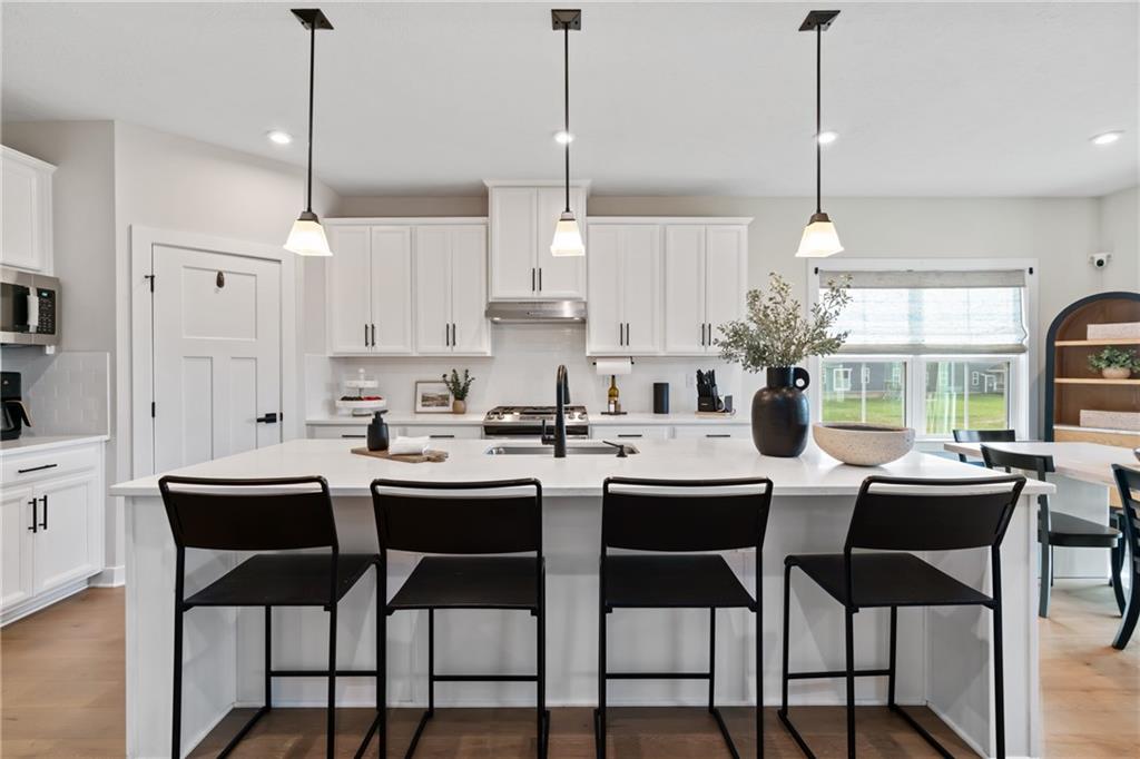 114 Marketplace Avenue Coraopolis, PA 15108 - Photo 6 of 32 a kitchen with appliances a dining table and chairs