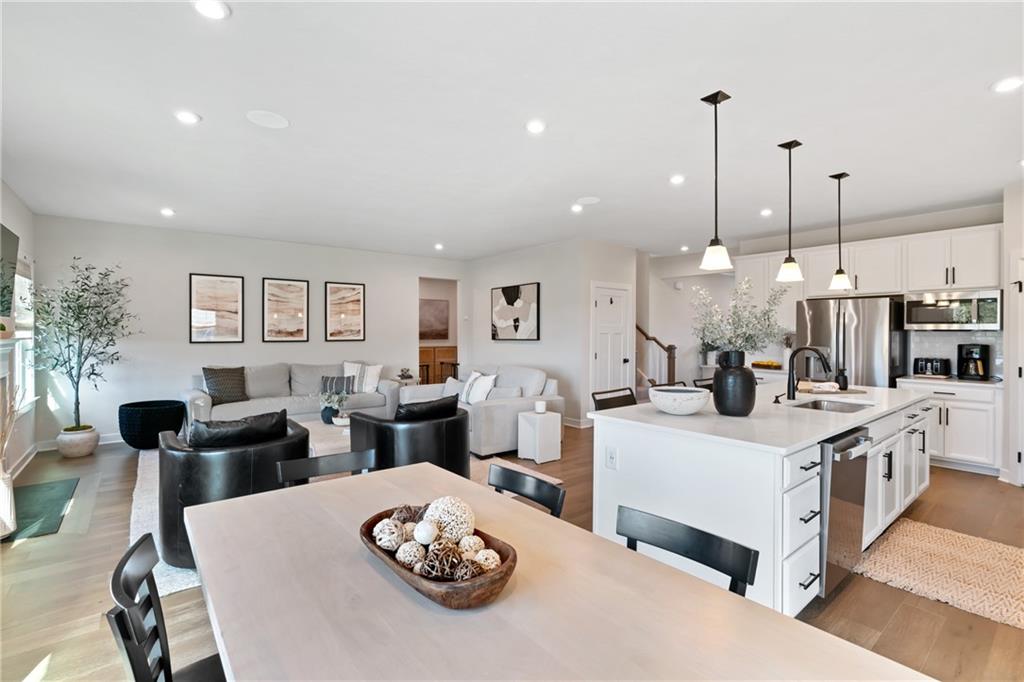 114 Marketplace Avenue Coraopolis, PA 15108 - Photo 8 of 32 a kitchen that has a lot of cabinets a sink and a wooden floor