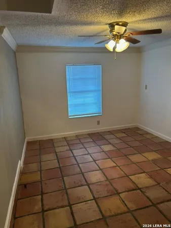 a view of a livingroom with an empty space and a window