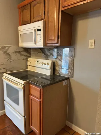 a kitchen with stainless steel appliances granite countertop a sink and cabinets