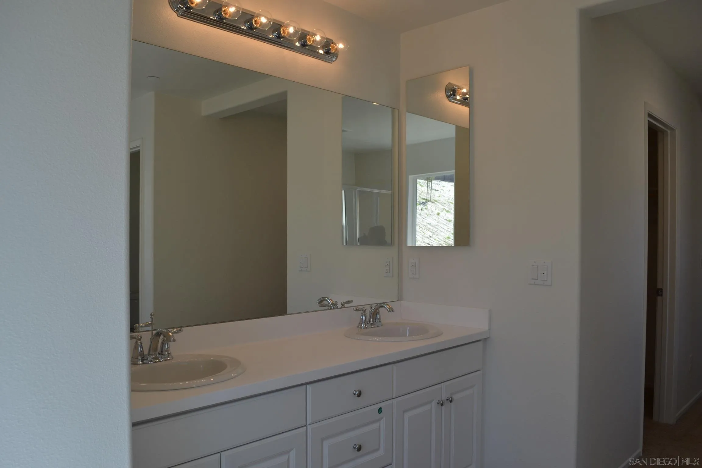 35329 White Camarillo Lane Fallbrook, CA 92028 - Photo 12 of 16 a bathroom with a sink vanity and mirror
