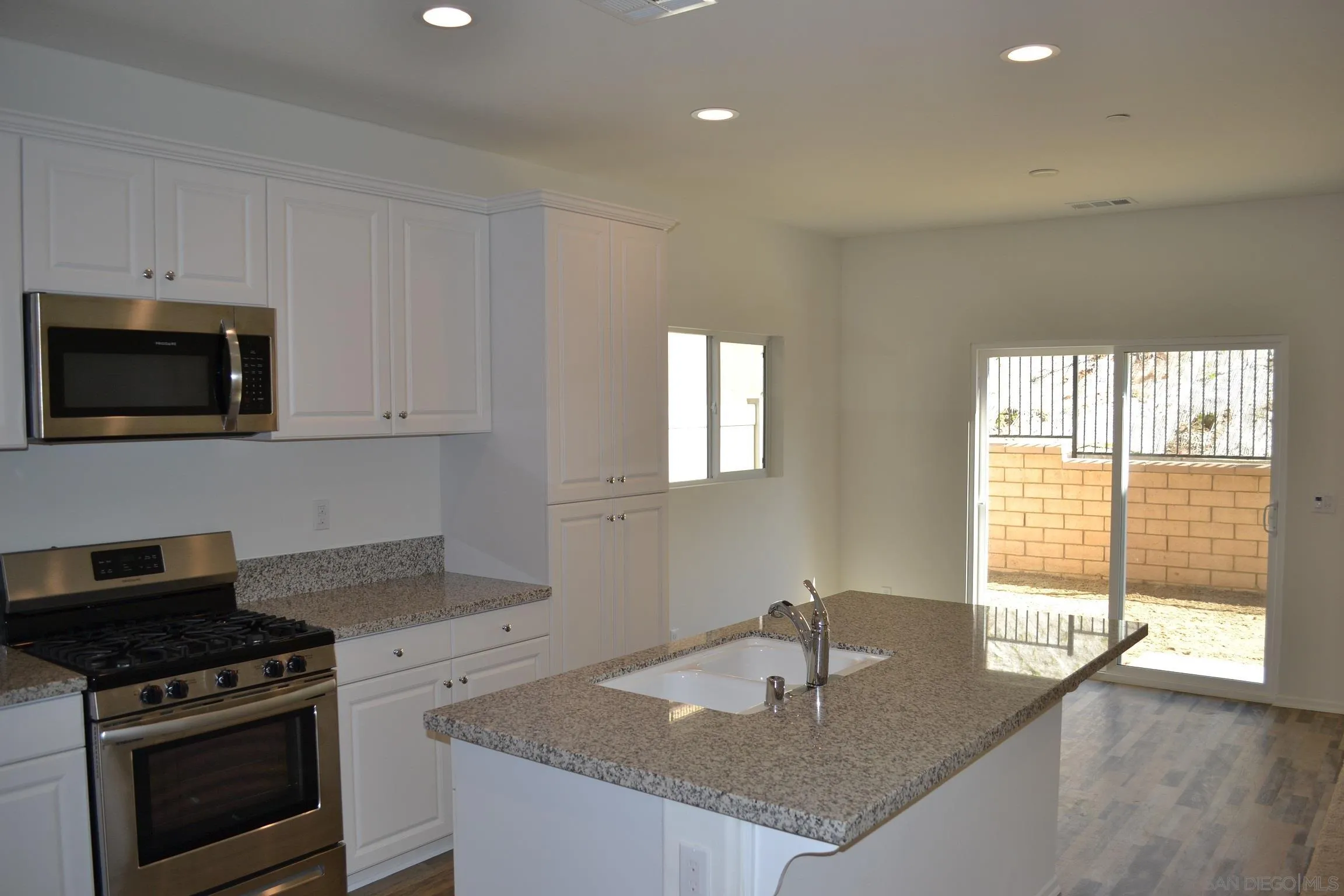 35329 White Camarillo Lane Fallbrook, CA 92028 - Photo 5 of 16 a kitchen with granite countertop a stove and a sink