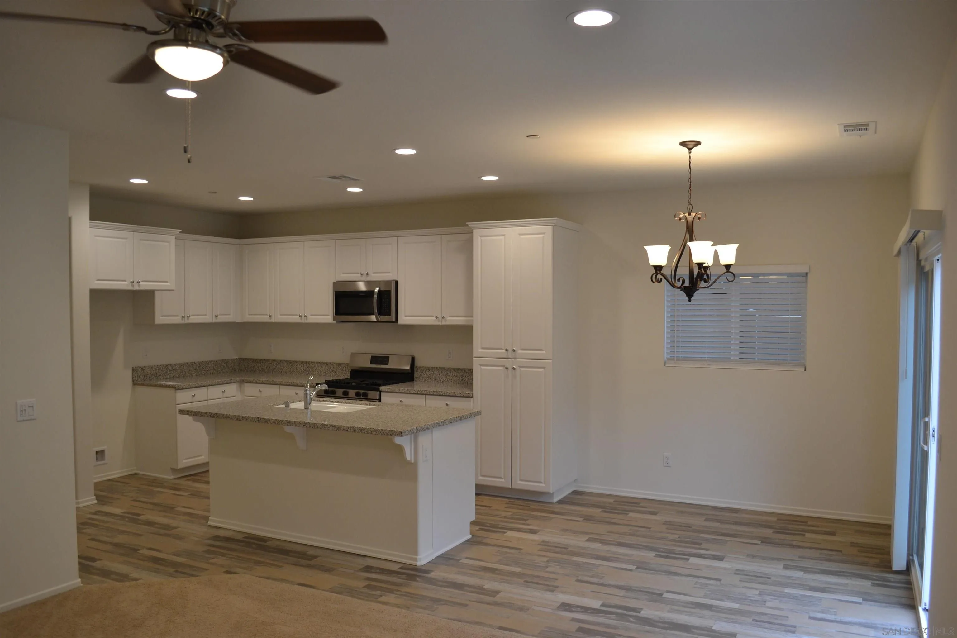 35329 White Camarillo Lane Fallbrook, CA 92028 - Photo 7 of 16 a kitchen with stainless steel appliances granite countertop a sink stove and refrigerator
