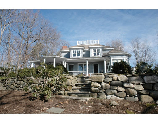 a front view of house with yard and trees around