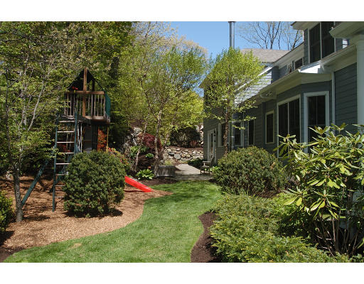 138 Partridge Lane Concord, MA 01742 - Photo 2 of 19 a view of a house with a small yard and plants