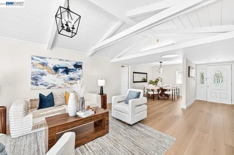 a living room with furniture window and wooden floor