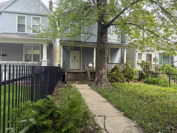 a front view of a house with a garden