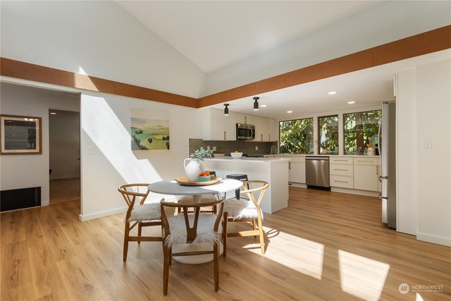 a kitchen with a table and chairs in it