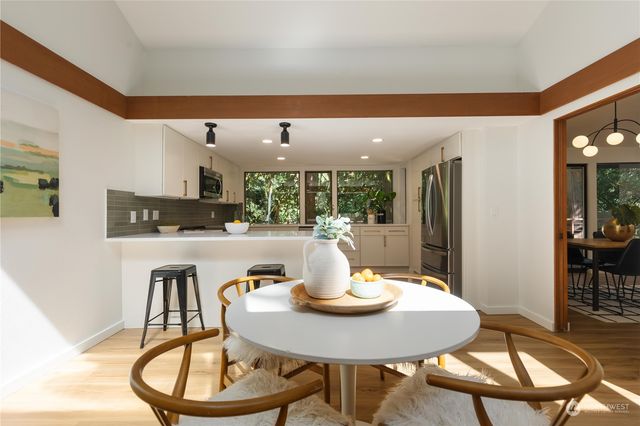 a kitchen with a dining table and chairs