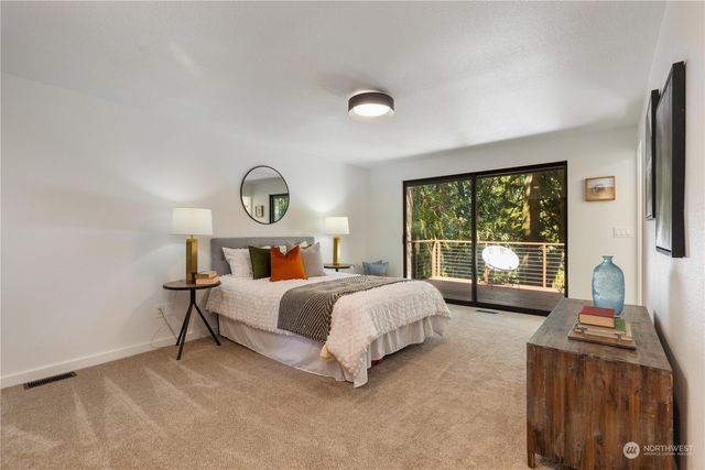 a bed room with a bed and a large window