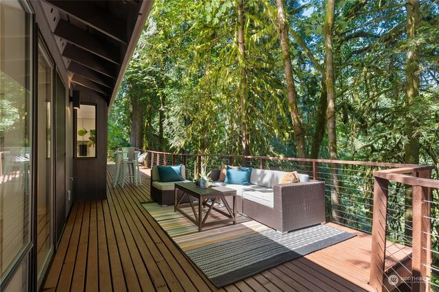 a view of roof deck with couches and wooden floor